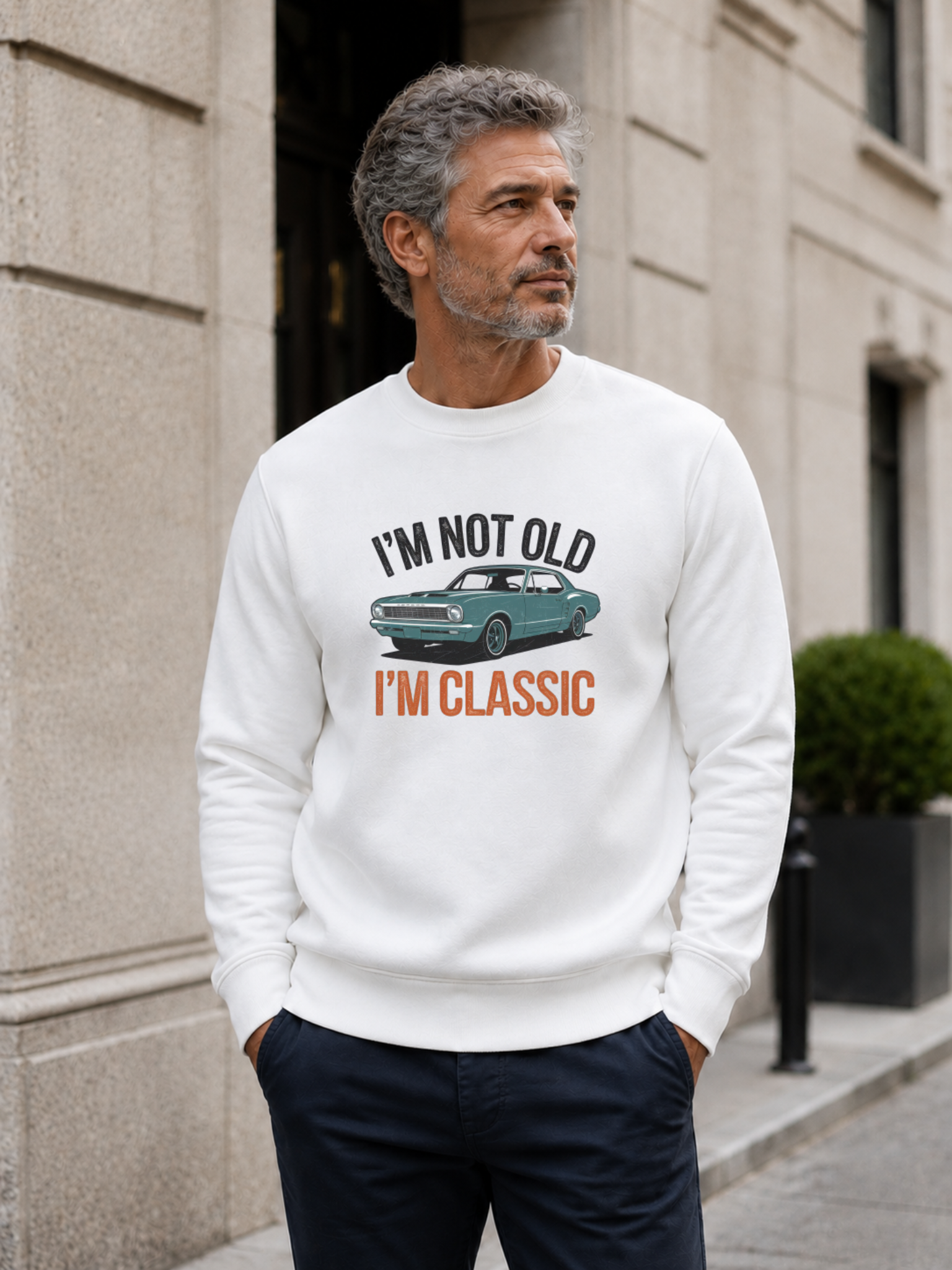 I'm Not Old I'm Classic sweatshirt featuring a vintage muscle car graphic and funny retro slogan worn by male model outdoors.