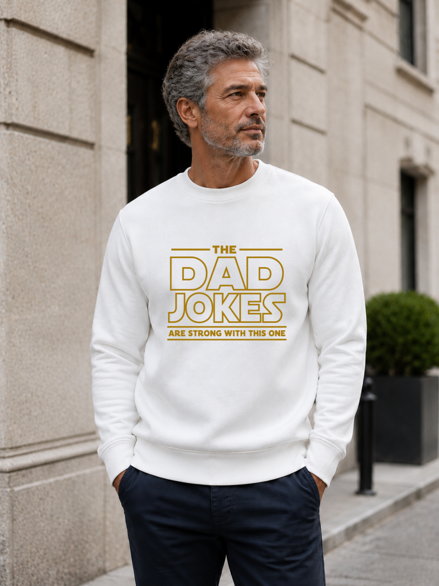 sweatshirt featuring a bold yellow “The Dad Jokes Are Strong With This One” design, modeled as a funny Father’s Day gift for dads who love humor.