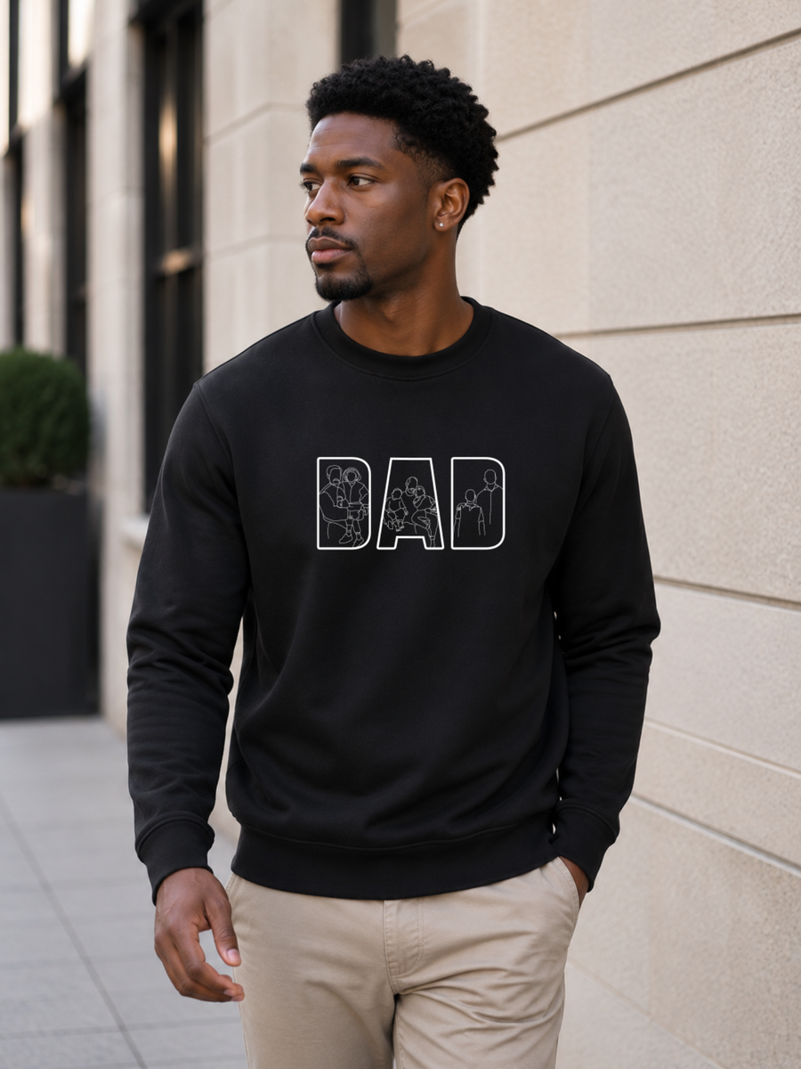 Minimalist black dad sweatshirt with white outline family artwork inside DAD lettering worn by male model outdoors.
