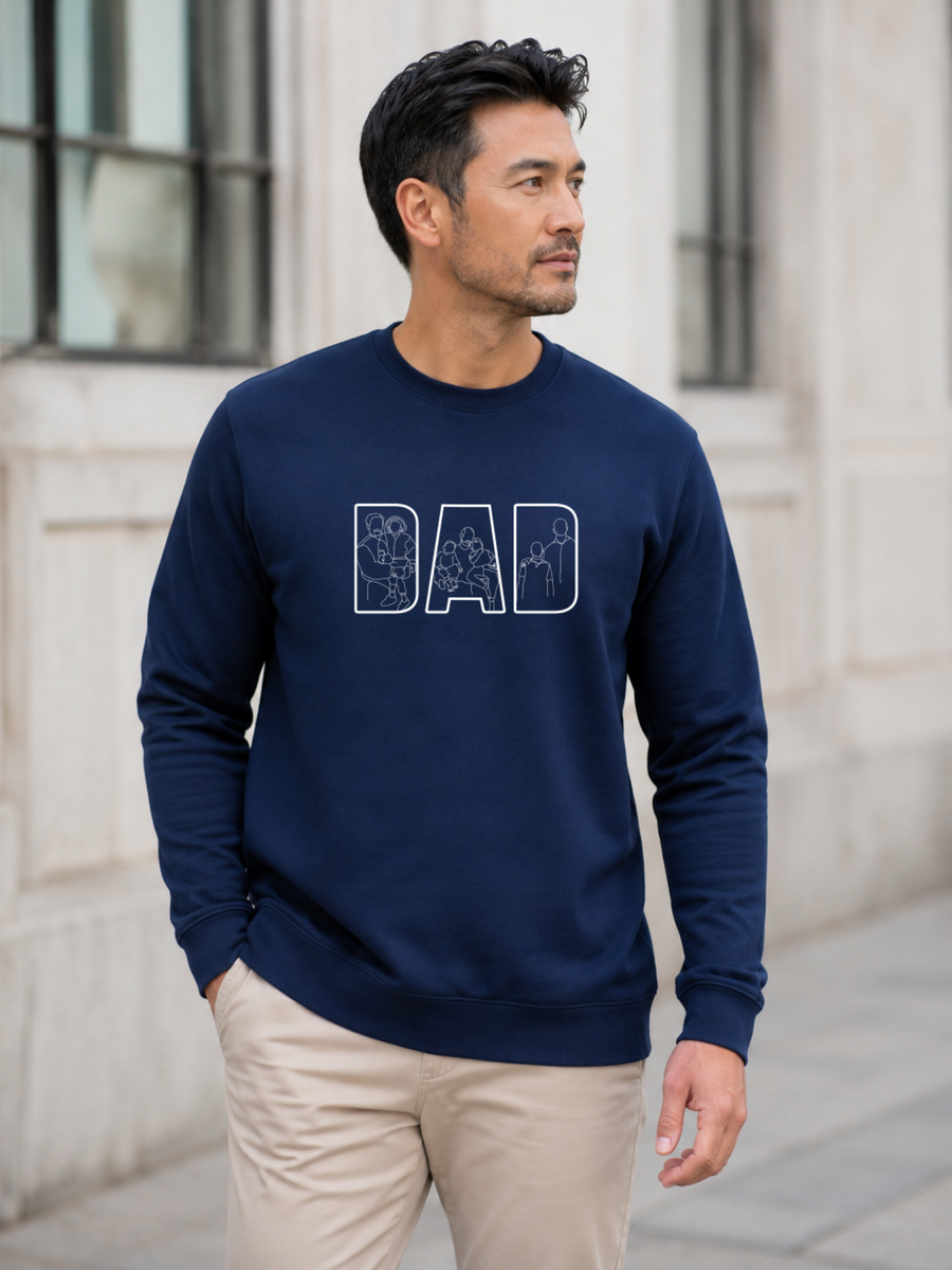Minimalist navy dad sweatshirt with white outline family artwork inside DAD lettering worn by male model outdoors.