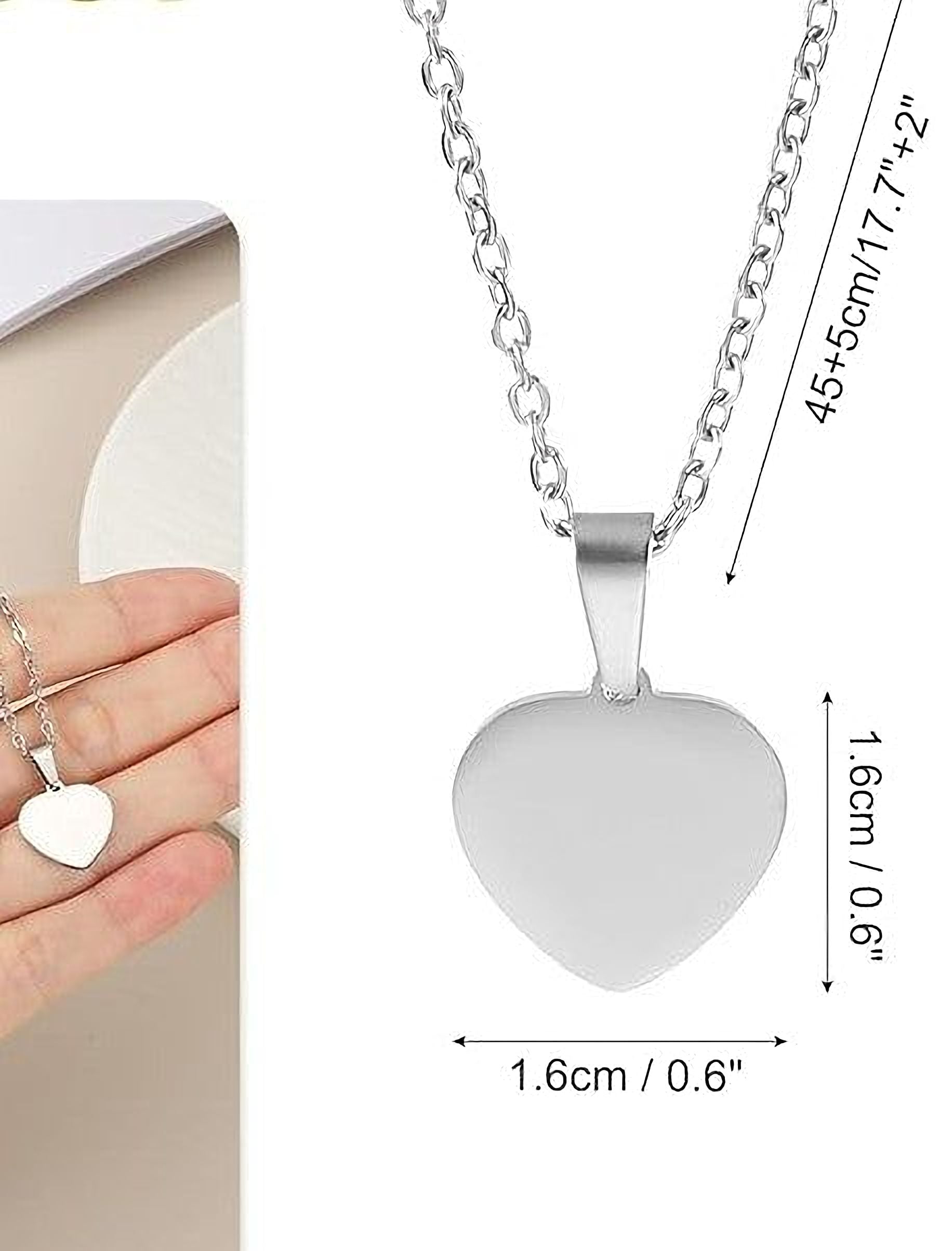 a silver heart-shaped pendant necklace with a chain, and there are measurements provided for the necklace.