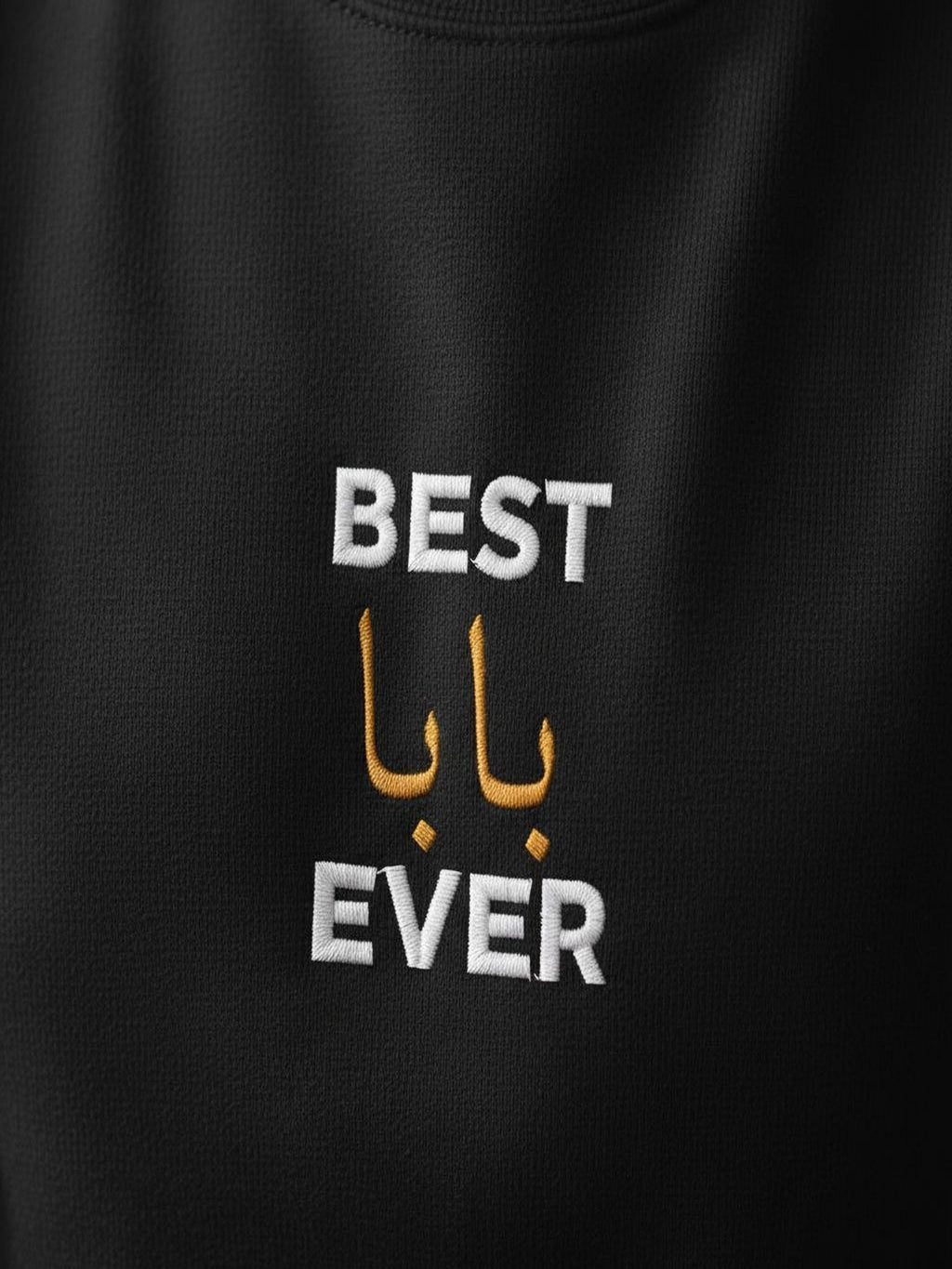 a black t-shirt with white text and two gold Arabic characters.