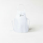 A white apron with the text "Chef Brandon" printed on it.