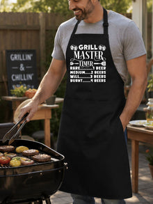 Grill Master Timer apron with funny beer and BBQ graphic design worn by man grilling burgers outdoors.