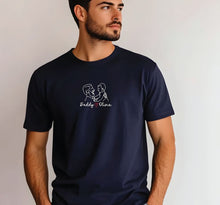 A man wearing a navy blue t-shirt with a white graphic design on it.