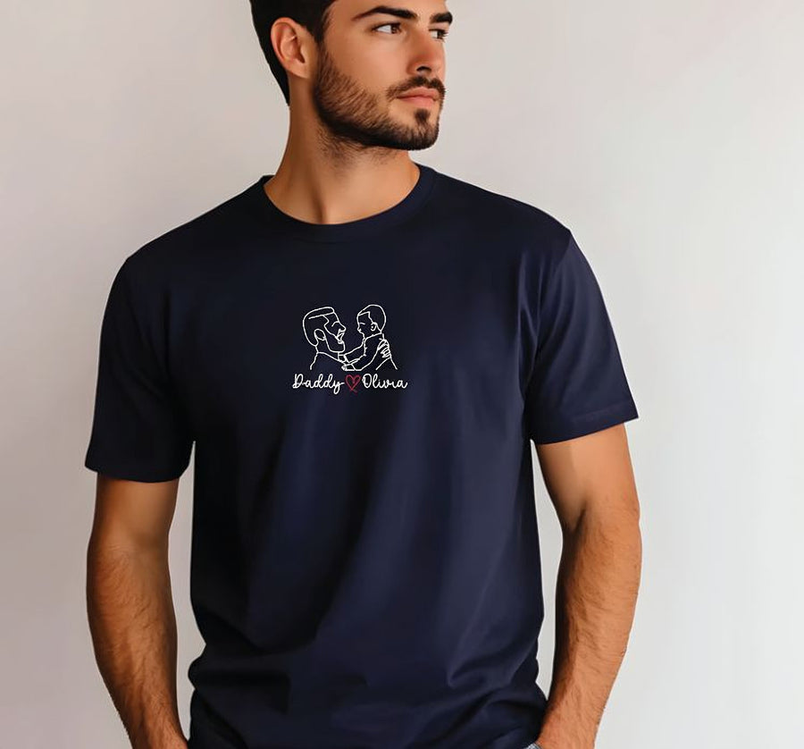A man wearing a navy blue t-shirt with a white graphic design on it.