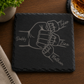 Personalized engraved black slate coaster featuring a fist bump design with Dad and children's names laser engraved on natural slate.