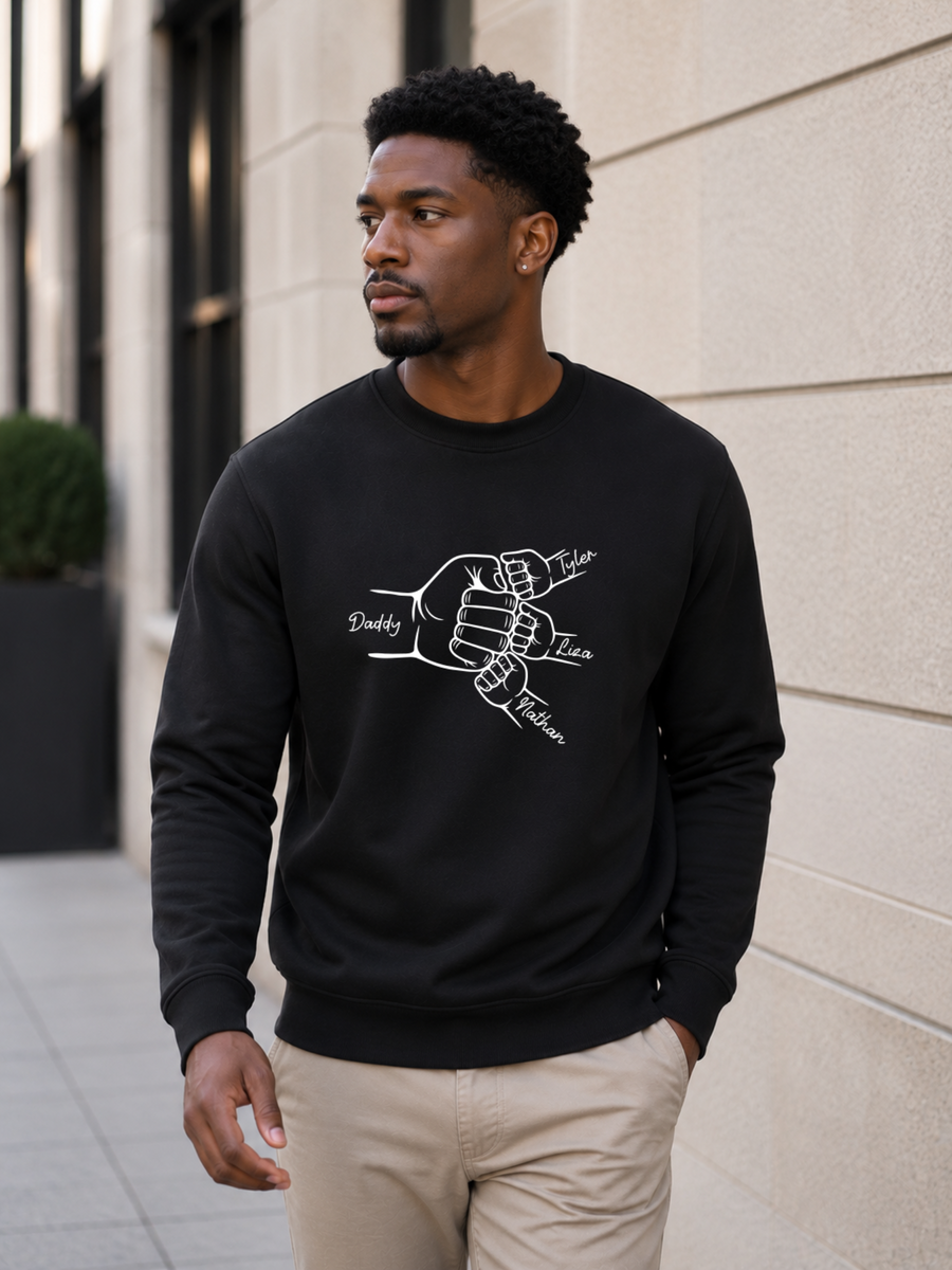 personalized dad sweatshirt featuring custom family fist bump outline artwork with children’s names worn by male model outdoors.