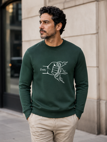personalized dad sweatshirt featuring custom family fist bump outline artwork with children’s names worn by male model outdoors.