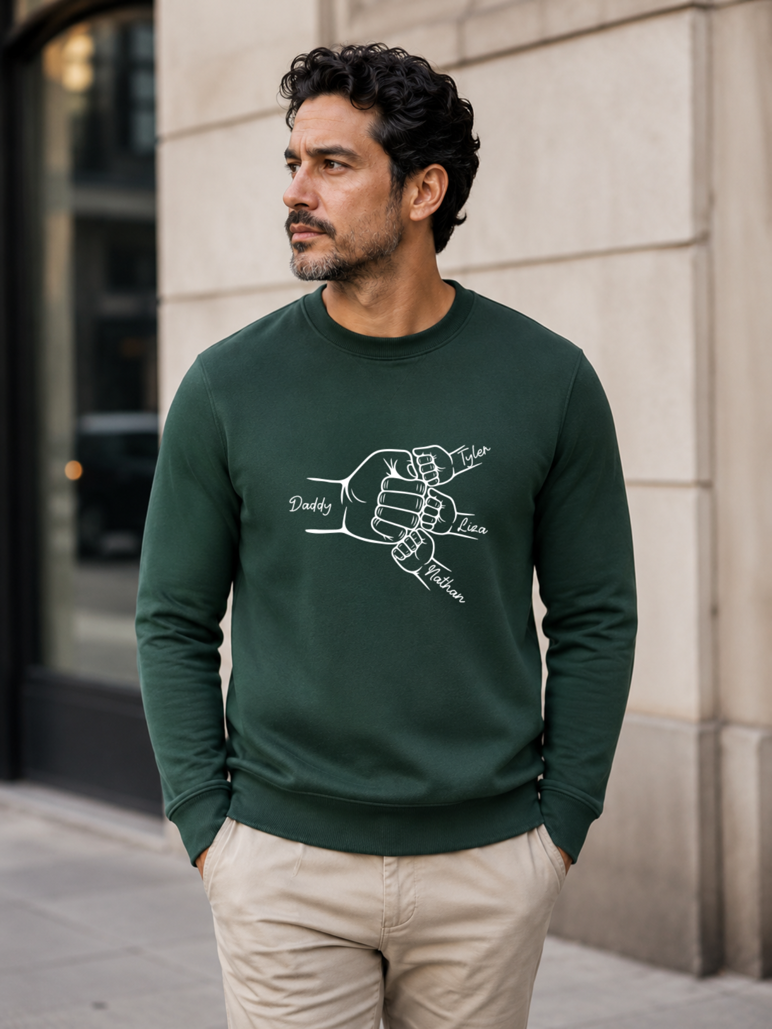 personalized dad sweatshirt featuring custom family fist bump outline artwork with children’s names worn by male model outdoors.