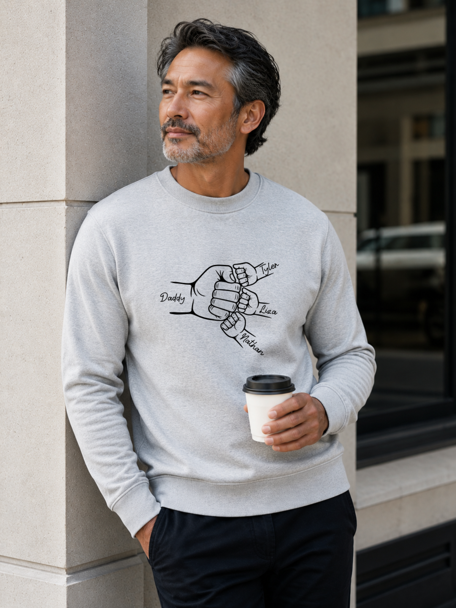 personalized dad sweatshirt featuring custom family fist bump outline artwork with children’s names worn by male model outdoors.