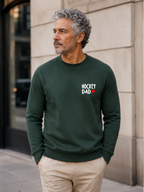 Hockey Dad crewneck sweatshirt featuring a minimalist white Hockey Dad design with a red Canadian maple leaf, modeled outdoors.