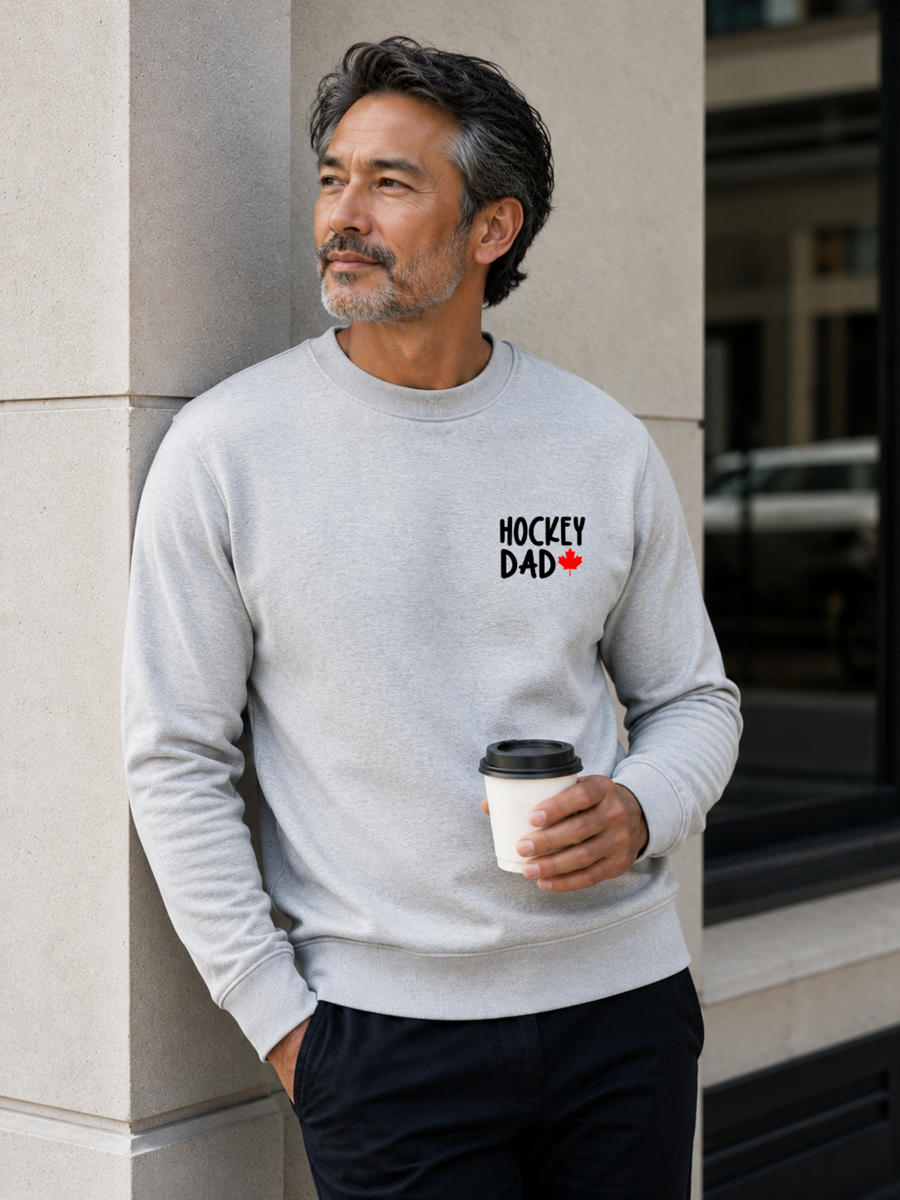 Hockey Dad crewneck sweatshirt featuring a minimalist white Hockey Dad design with a red Canadian maple leaf, modeled outdoors.