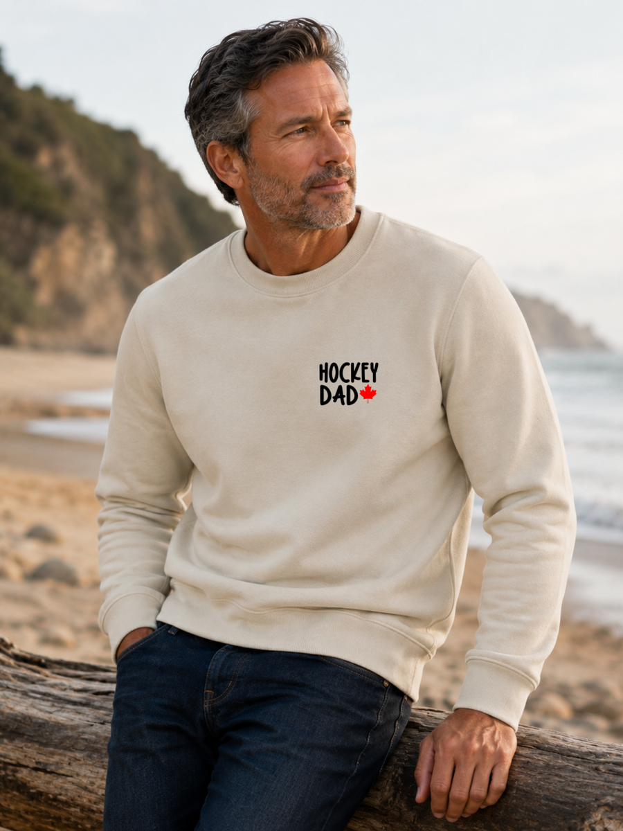 Hockey Dad crewneck sweatshirt featuring a minimalist white Hockey Dad design with a red Canadian maple leaf, modeled outdoors.