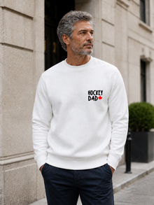 Hockey Dad crewneck sweatshirt featuring a minimalist white Hockey Dad design with a red Canadian maple leaf, modeled outdoors.
