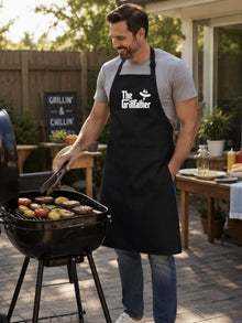 Man grilling outdoors wearing a 'The Grillfather' apron