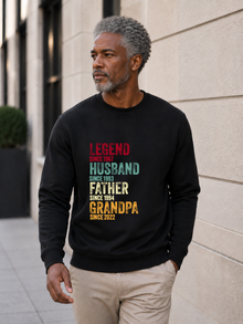 personalized Legend Husband Father Grandpa sweatshirt with vintage distressed typography and custom years worn by mature male model outdoors.