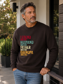 personalized Legend Husband Father Grandpa sweatshirt with vintage distressed typography and custom years worn by mature male model outdoors.