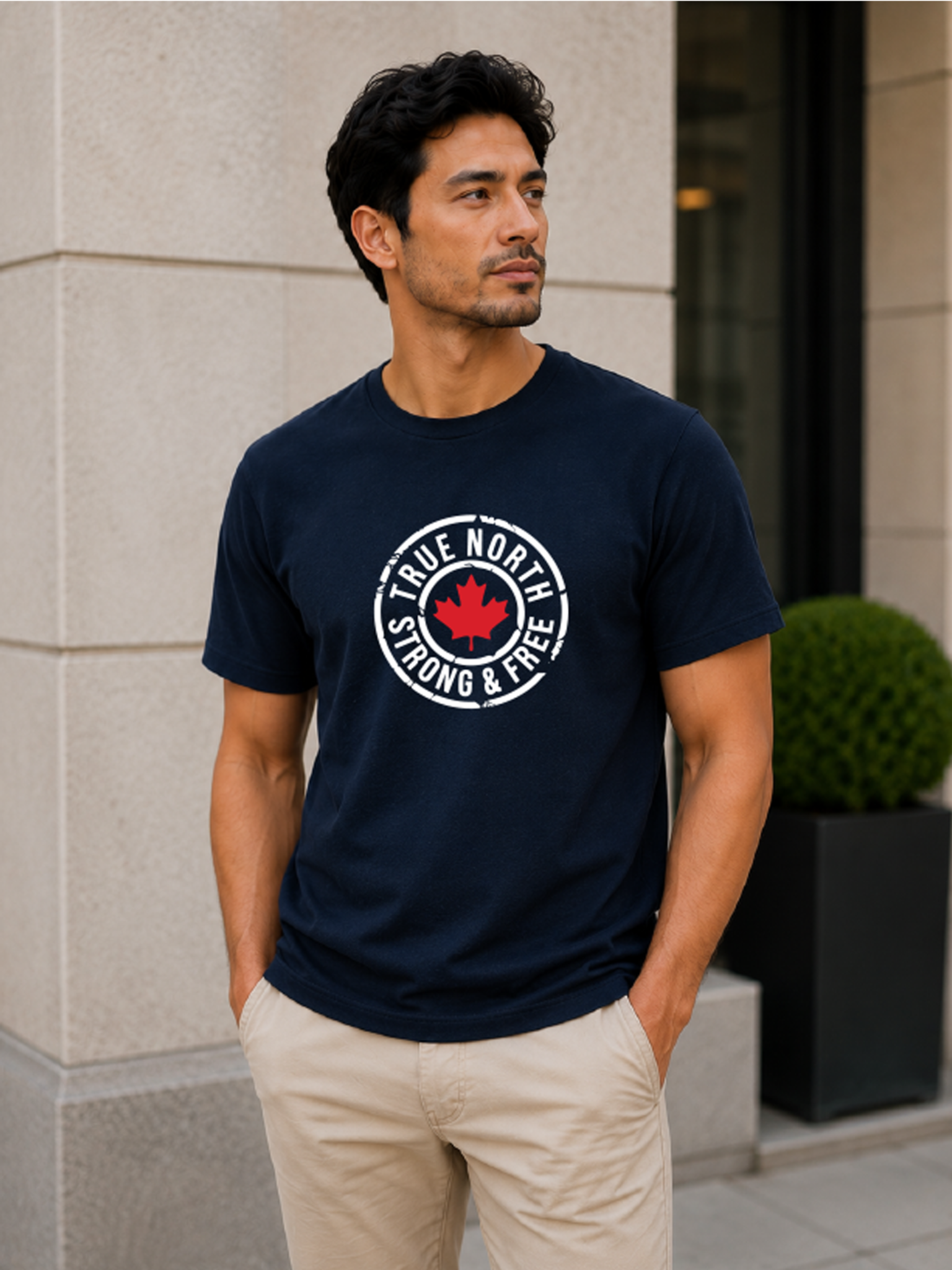 Male model wearing a navy blue True North Strong & Free Canada t-shirt featuring a distressed maple leaf graphic and patriotic Canadian design.