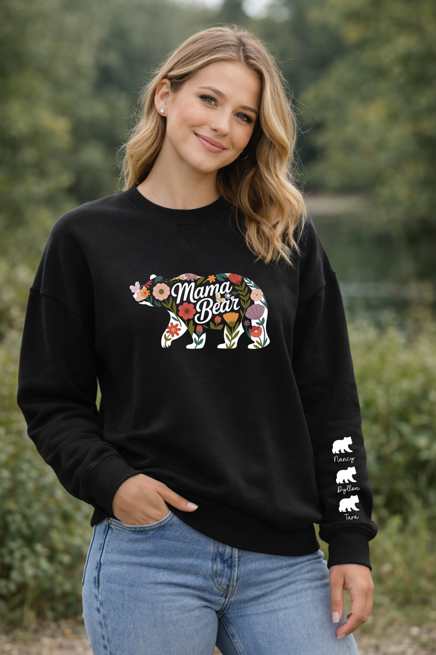 Woman wearing a black sweatshirt with 'Mama Bear' design outdoors