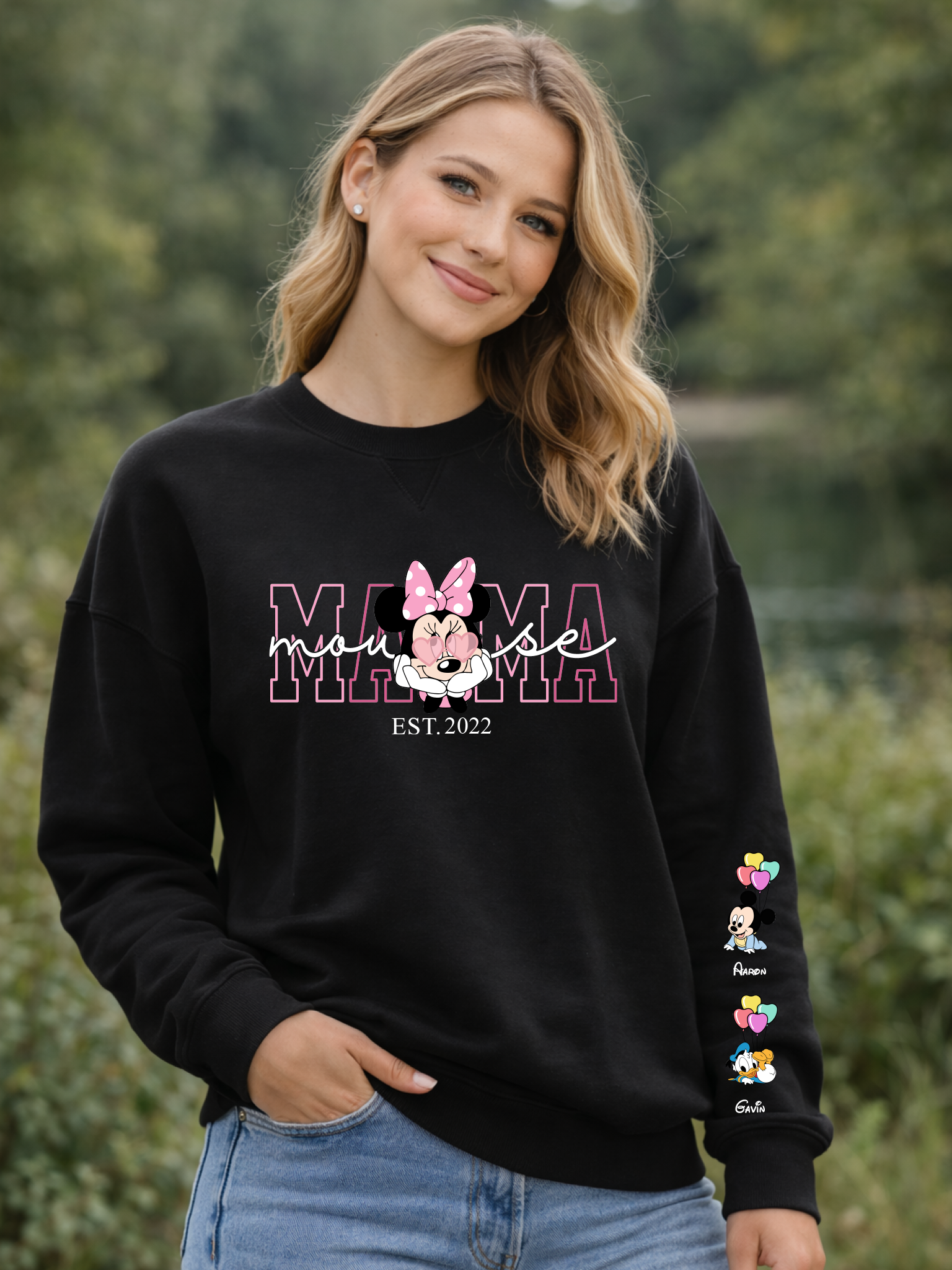 Woman wearing a black sweatshirt with a colorful design outdoors