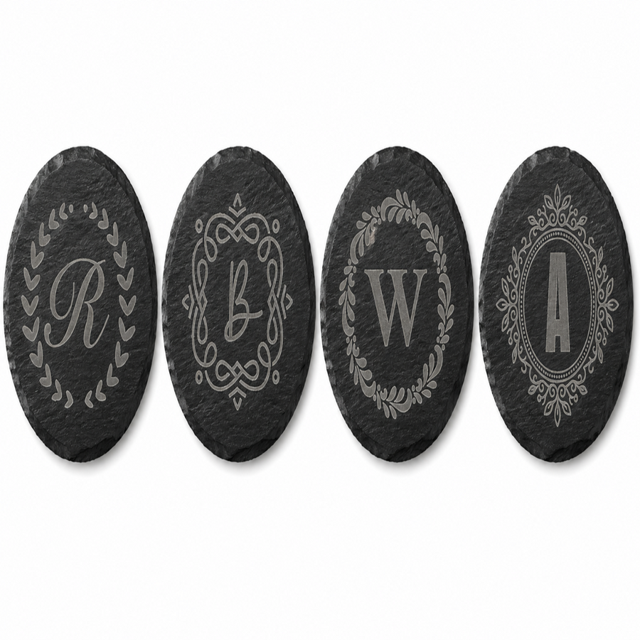 Personalized round black slate coaster engraved with custom monogram initial, elegant decorative border design, custom wedding and housewarming gift.