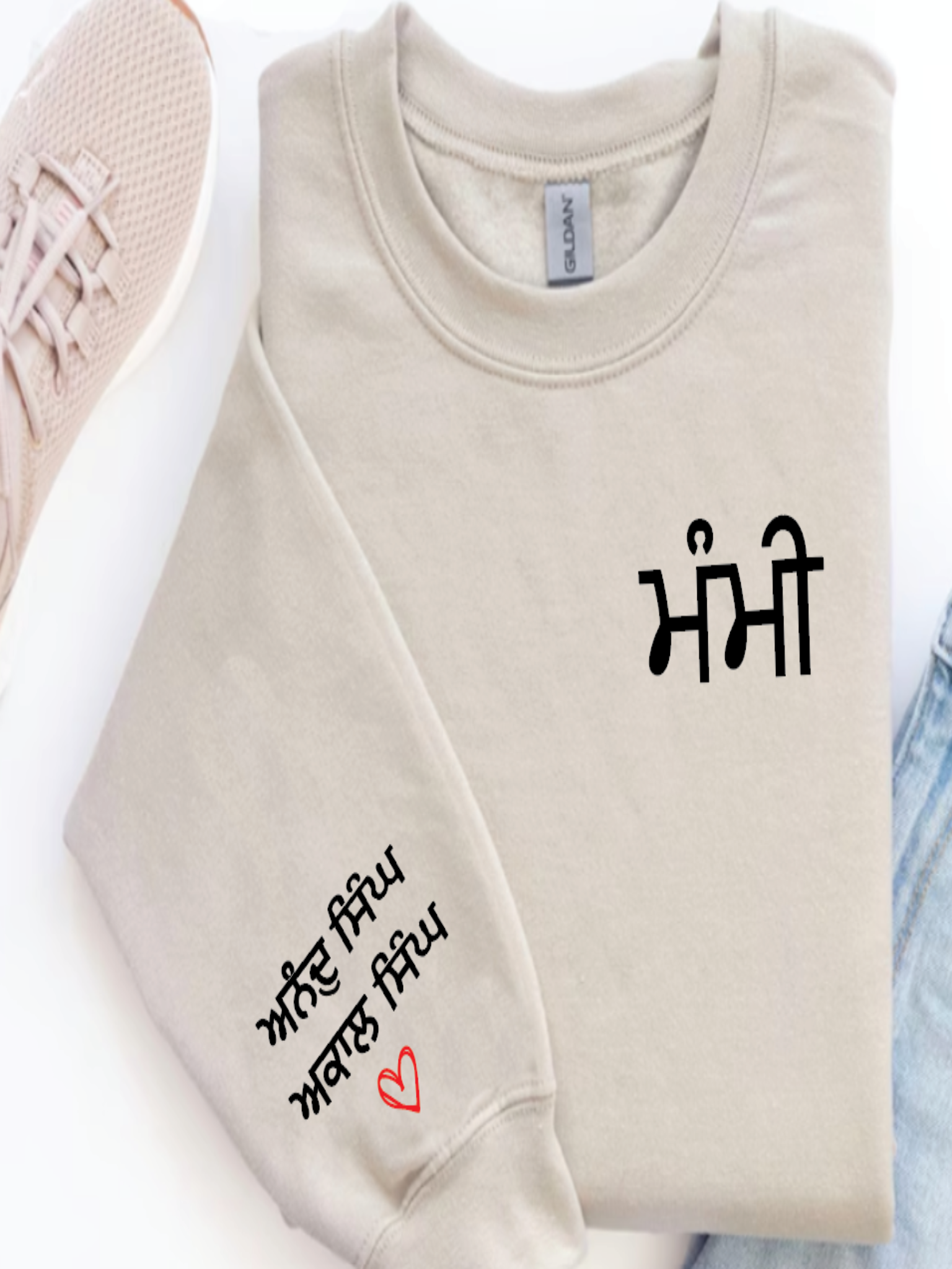 Beige sweatshirt with text and a heart design on a white background