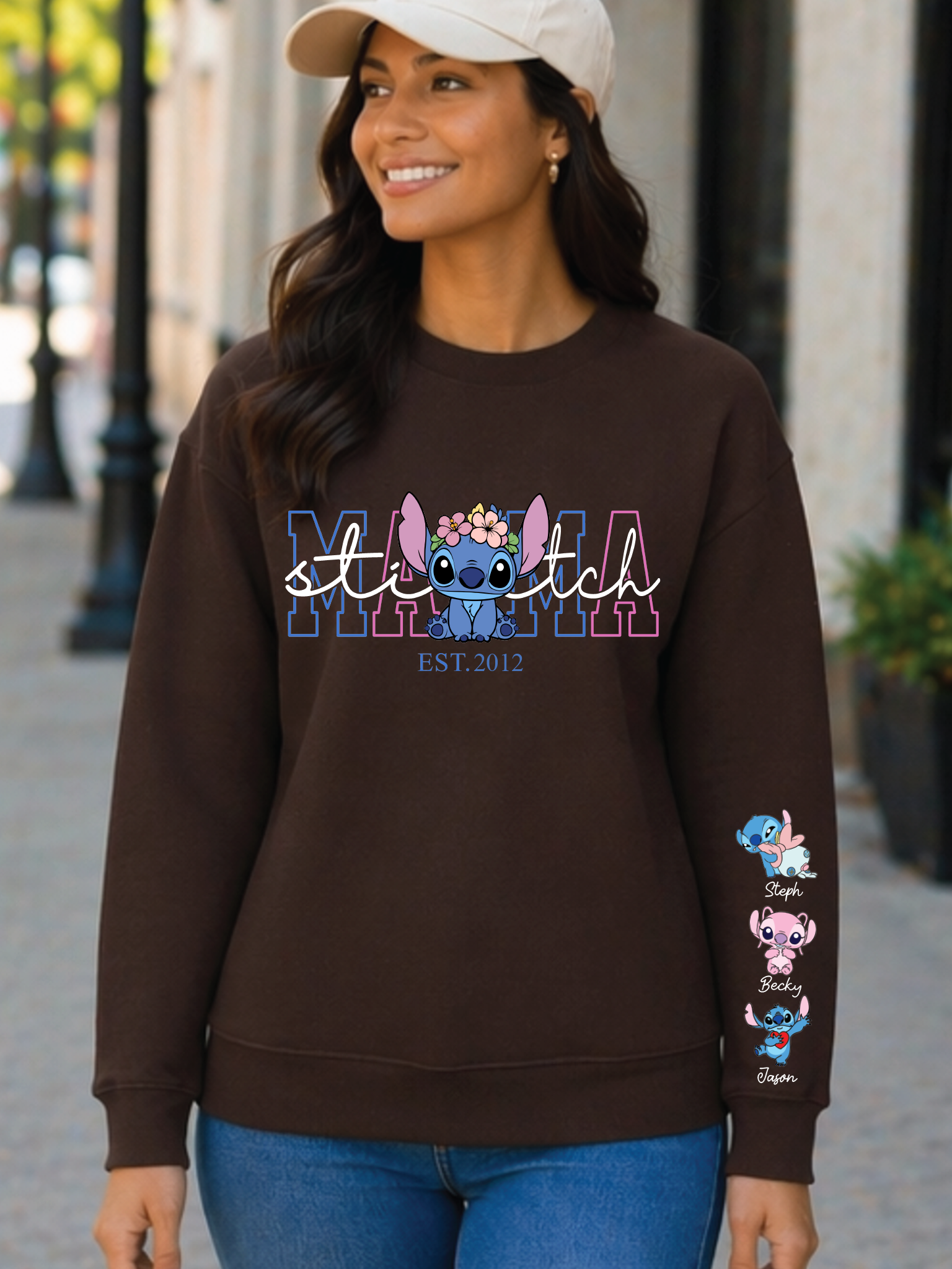 Woman wearing a brown sweatshirt with 'stitch' design on a city street.