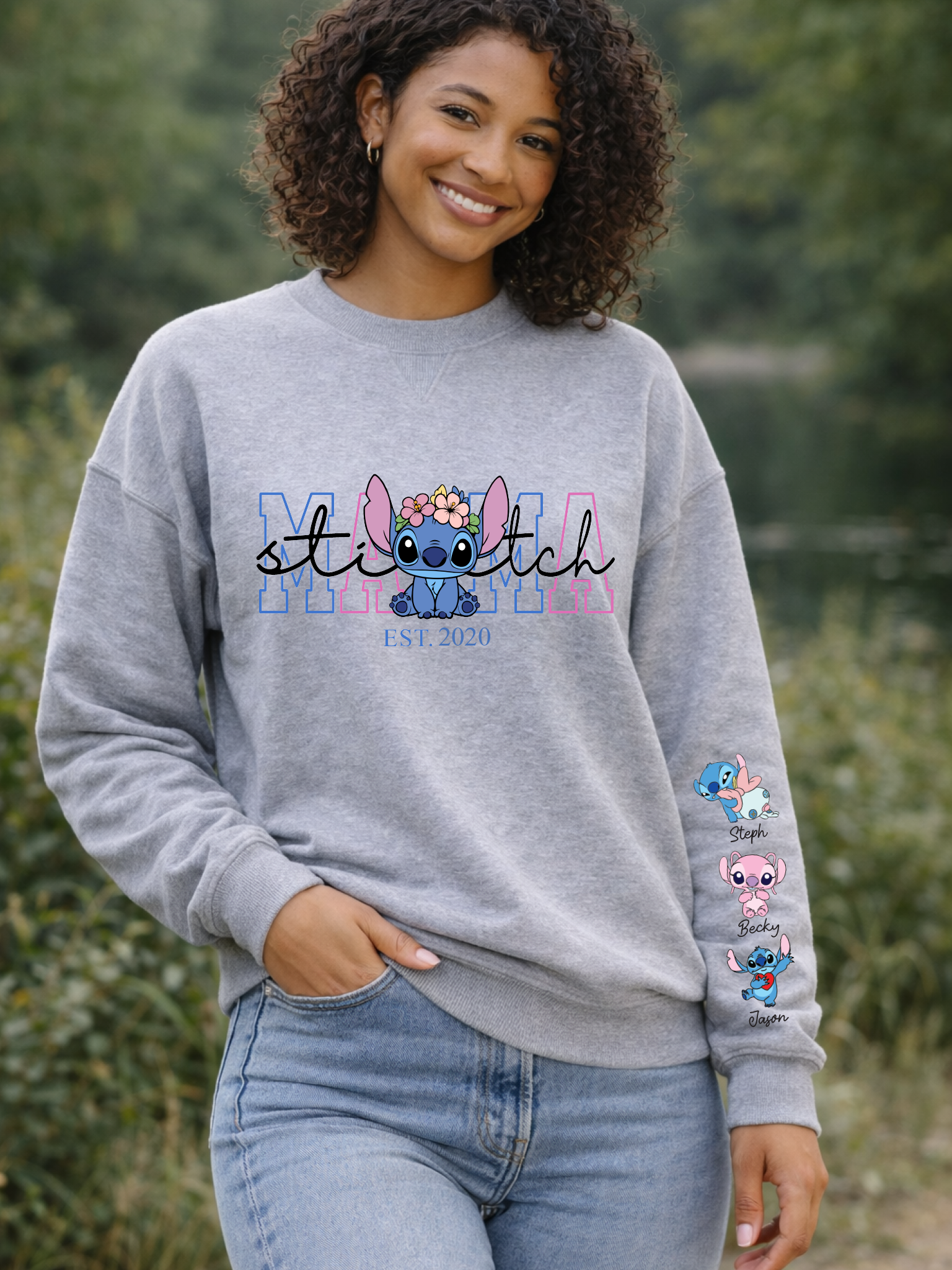 Person wearing a gray sweatshirt with 'Stitch' design, standing outdoors.