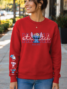 Person wearing a red 'Stitch' themed sweatshirt with character designs on sleeves.