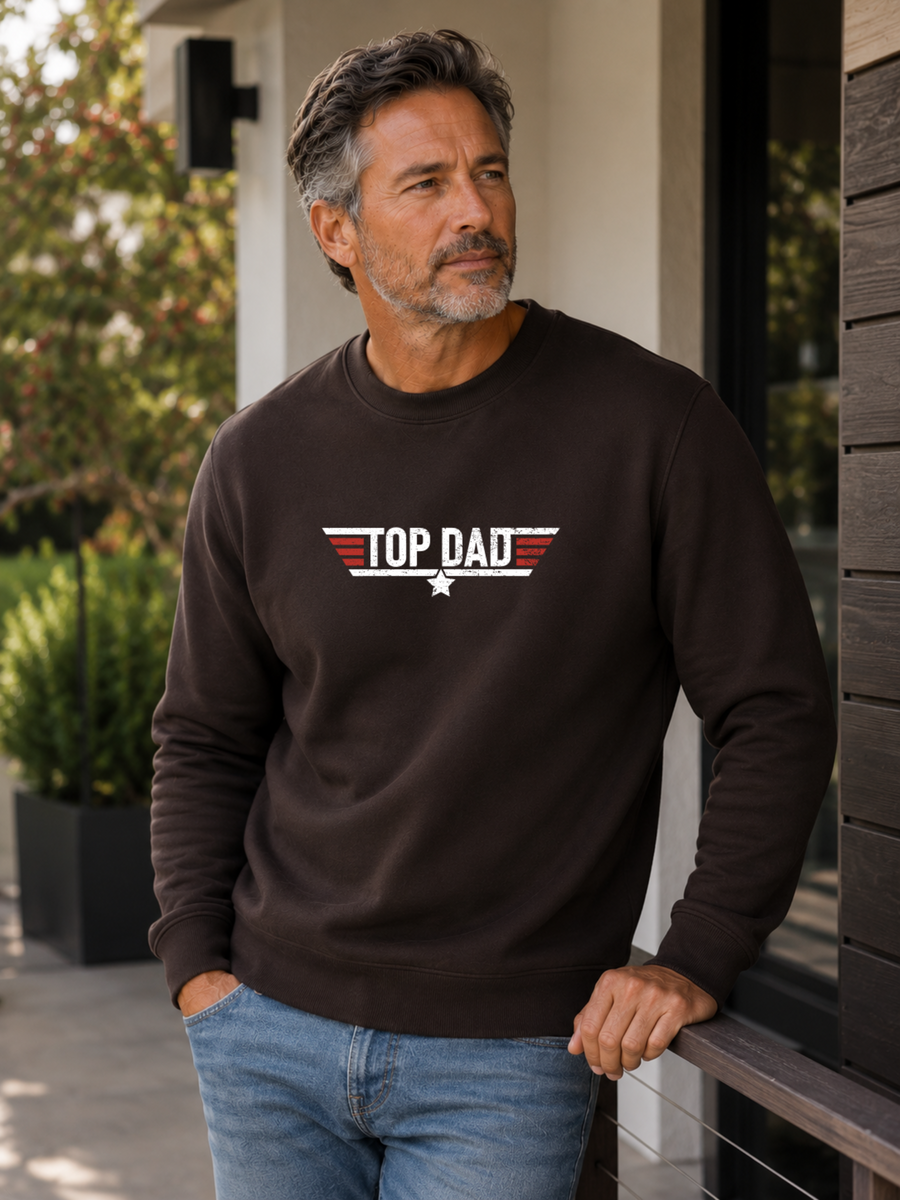 Top Dad sweatshirt featuring vintage distressed Father's Day graphic with patriotic stripes and star design worn by male model outdoors.