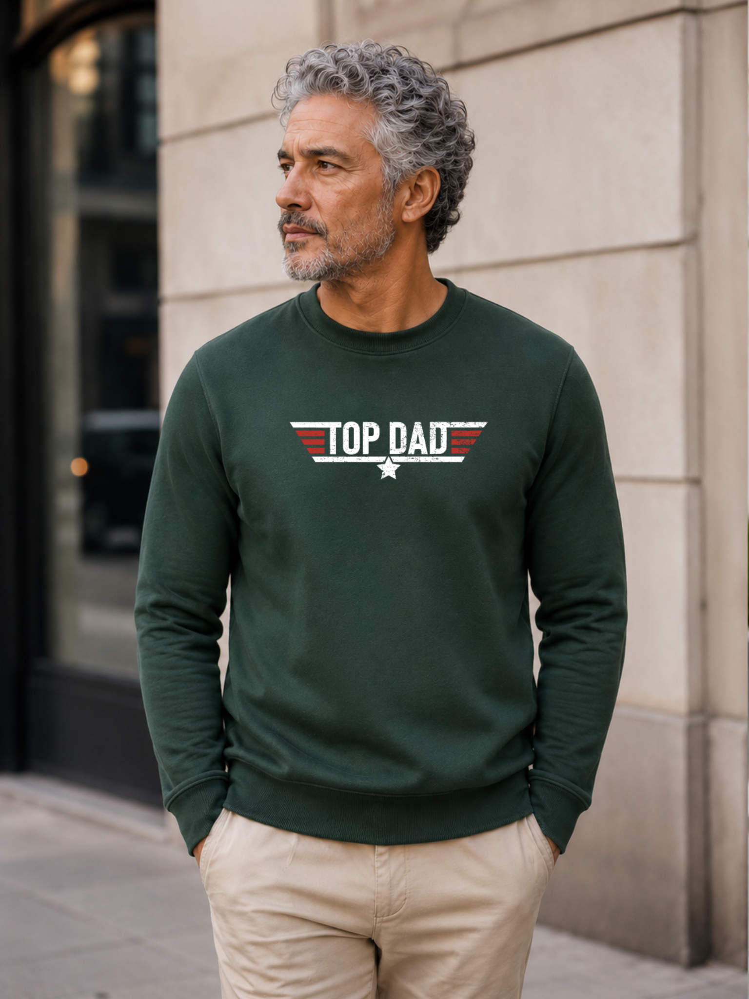 Top Dad sweatshirt featuring vintage distressed Father's Day graphic with patriotic stripes and star design worn by male model outdoors.