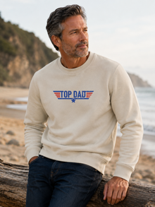 Top Dad sweatshirt featuring vintage distressed Father's Day graphic with patriotic stripes and star design worn by male model outdoors.